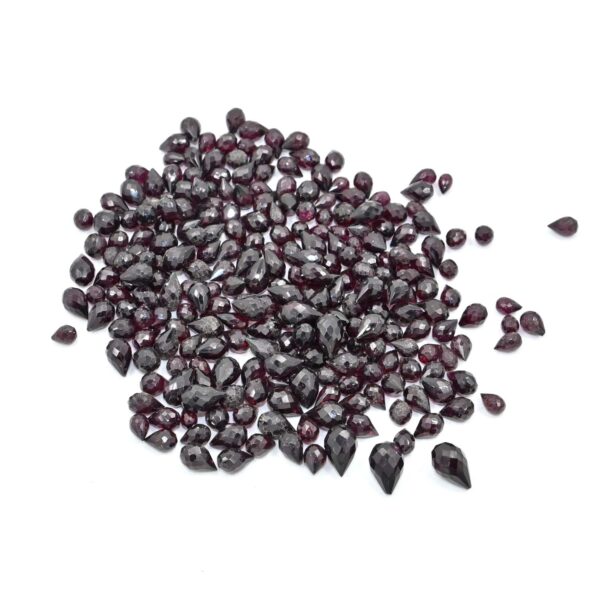 Shop 5x7mm faceted garnet drop beads in a 7" strand. Natural red gemstones ideal for DIY jewelry